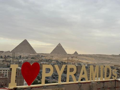 a sign that reads pyramids with a red heart at Separate hotel rooms with a view of the pyramids in Cairo