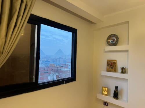 a window with a view of a city at Separate hotel rooms with a view of the pyramids in Cairo