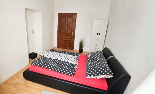 a bed in a room with two pillows on it at Apartmán na Krajzontě in Polná