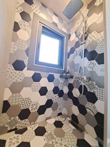 a bathroom with a shower and a window at Chunfang Residence in Fangliao