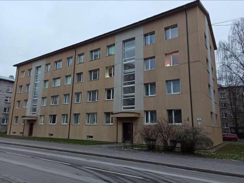 a large brick building on the side of a street at Sikupilli Pallasti Apartment in Tallinn