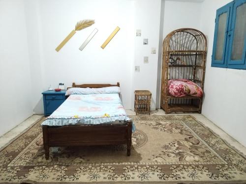 a bedroom with a bed and a crib in a room at منزل سيد سعد in Cairo