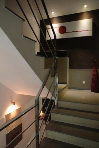 a staircase in a house with a red item on the wall at Hostal Central in Ceuta