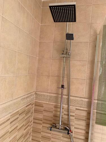 a shower with a shower head in a bathroom at Puerto Del Carmen - Apartment 5 - Las Palmeras 3 in Puerto del Carmen