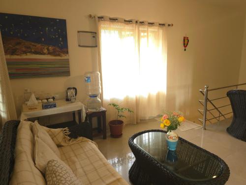 a living room with a couch and a glass table at Bella Boutique Homestay in Alleppey