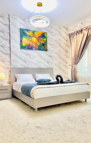 a bedroom with a bed with a painting on the wall at Best Place Holiday Home Free Parking in Ajman 