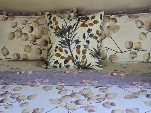 a group of pillows sitting on top of a bed at Bella Boutique Homestay in Alleppey