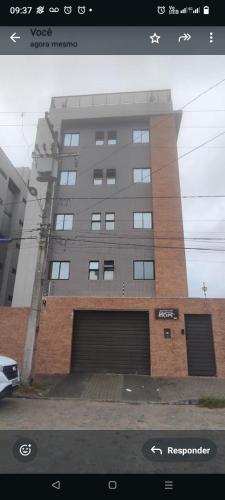 a large building with two garage doors in front of it at Hope Intermares in Cabedelo