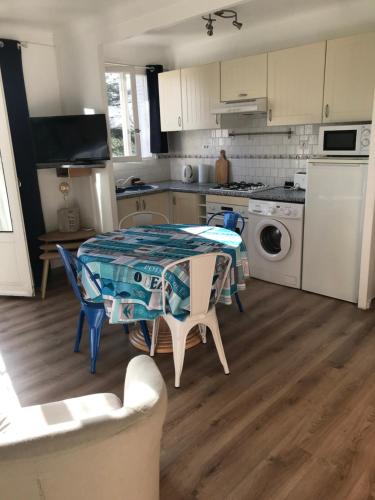une cuisine avec une table recouverte d'une nappe dans l'établissement Appartement Type F2 climatise entre plage et port, à Argelès-sur-Mer