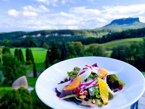 a plate with a salad with fruit and vegetables at Hotel Bei Gretel, Wellness & Ayurveda in Struppen-Siedlung