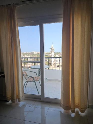 a sliding glass door with a view of a balcony at Hurghada Village sea view in Hurghada