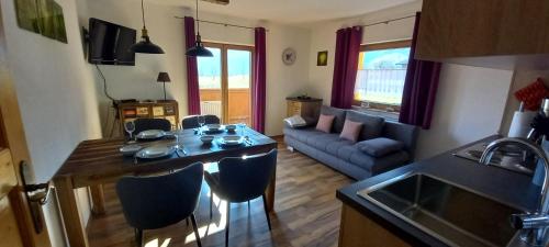 a kitchen and living room with a table and a couch at Apartment Birgit in Uderns