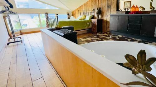 Un baño con bañera y un dormitorio. en Carwyns Surf House, en Seignosse