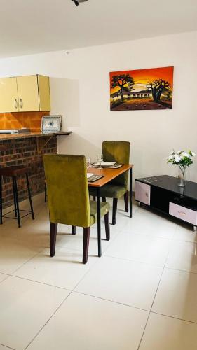 a dining room with a table and two chairs at Sibusi Guesthouse in Richards Bay