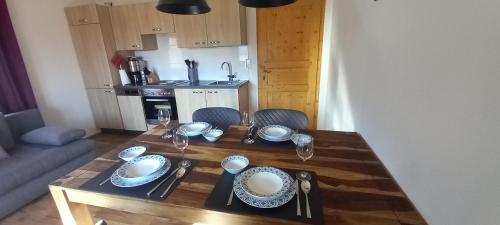 a wooden table with plates and dishes on top of it at Apartment Birgit in Uderns