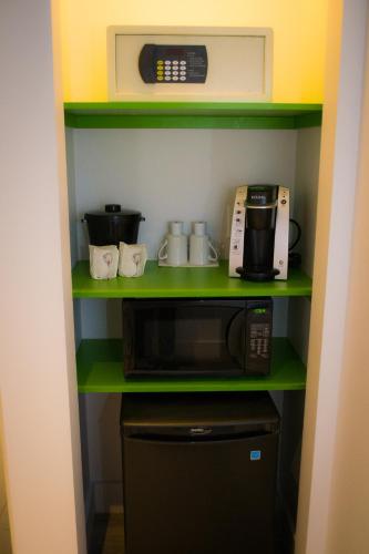 a kitchen with a microwave and a coffee maker at Hotel V in Gatineau
