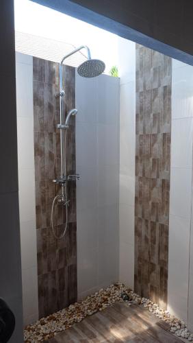 a bathroom with a shower with a glass door at Lullaby Boutique Resort in Thap Sakae