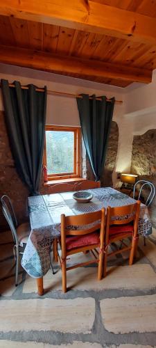 a table and chairs in a room with a window at Villa Sarichel in Nikithianós