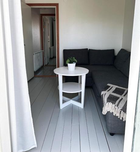 a living room with a couch and a table at Villa Beddingestrand in Beddinge Strand