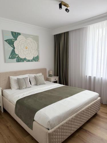 a bedroom with a large bed in a room at Aman 20 in Craiova