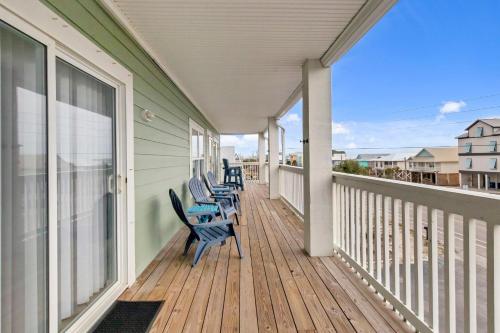 a porch with chairs on it with a view of the ocean at 3BR Condo Gulf Views with Pool, Boat Launch and Dock in Gulf Shores