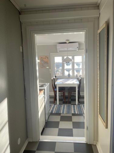 a kitchen with a table and a dining room at Vinberga in Enhörna