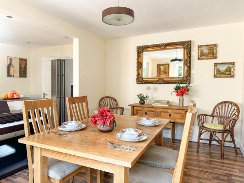 a kitchen and dining room with a table and a piano at Perfect Getaway in Canterbury in Canterbury
