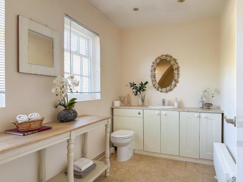 a bathroom with a toilet and a sink and a mirror at Perfect Getaway in Canterbury in Canterbury