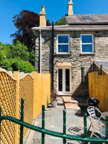 a wooden fence in front of a house at Mount Cottage in Newcastle Emlyn
