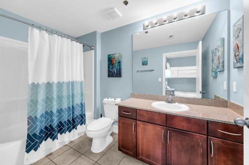 a bathroom with a toilet and a sink and a shower at Laketown Wharf 317 in Panama City Beach