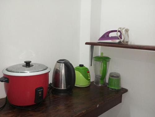a counter with a toaster and a blender on a shelf at sajini home stay in Pilana