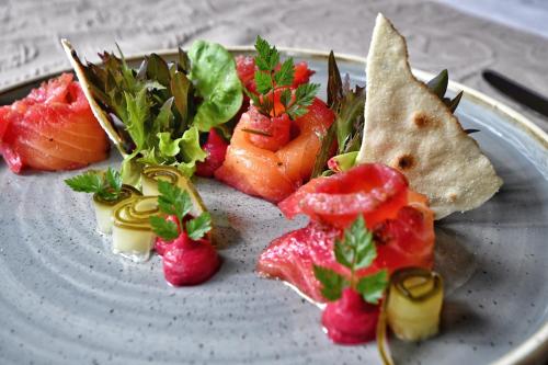 a plate of food with strawberries and vegetables on it at Hotel Gasthaus Hirschen in Baden