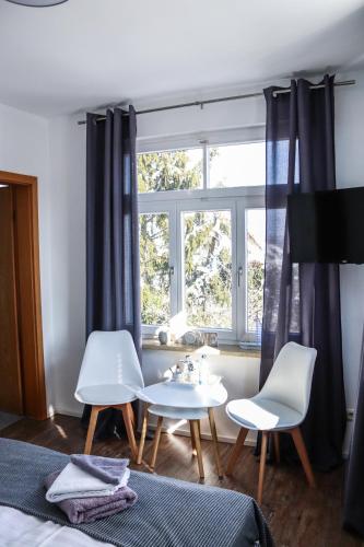 Ένα ή περισσότερα κρεβάτια σε δωμάτιο στο Gasthaus Wilhelmshöhe