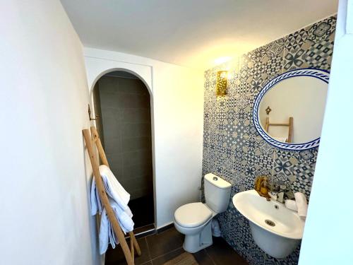 a bathroom with a toilet and a sink and a mirror at Riad Nabil with Concierge and FREE Breakfast in Marrakech