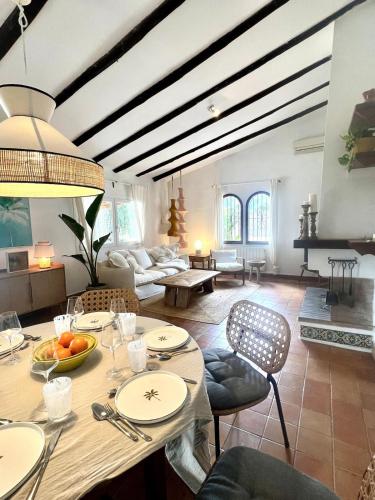 a living room with a table and a couch at Finca es Born - vistas panorámicas in Esporles