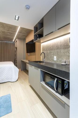 a kitchen with a sink and a bed in a room at Setai Yacht by DayByDay in João Pessoa