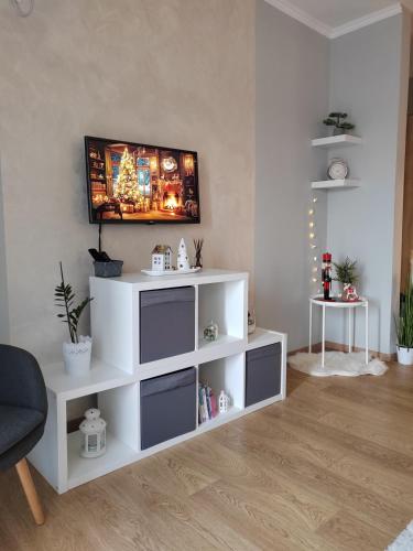 a living room with a white entertainment center at Apartman Lola in Subotica