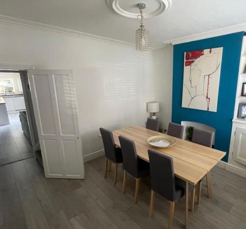 a dining room with a wooden table and chairs at Whole House - 5 mins to train station, M1 & M69 in Enderby