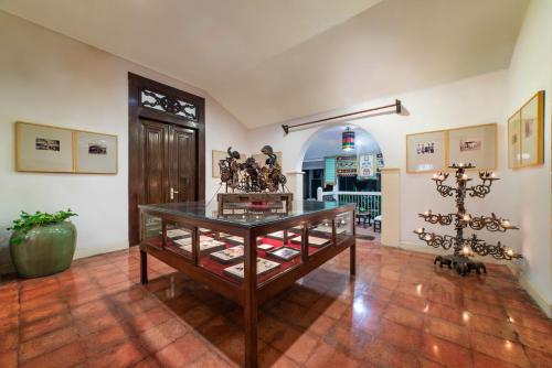 a room with a glass table with items on it at Hotel Tugu Blitar in Blitar