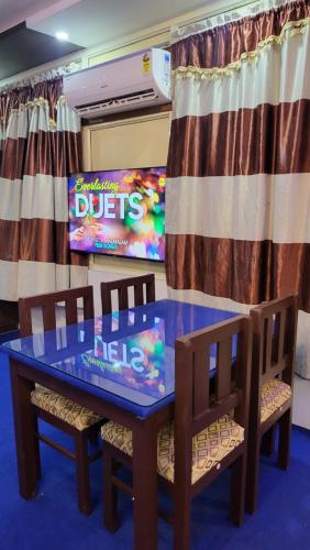 a dining room with a table and two chairs at Hill View Homes,AC Suites in trivandrum in Trivandrum
