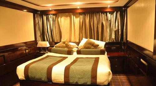 a bedroom with a large bed and a window at مركب ريفر River Boat in Cairo