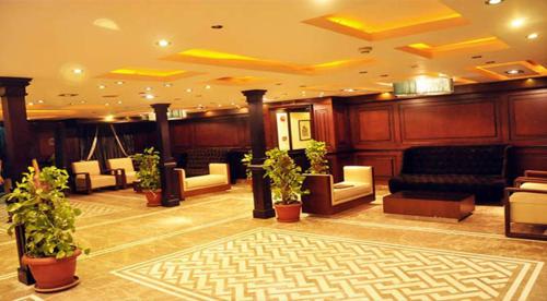 a lobby with couches and potted plants at مركب ريفر River Boat in Cairo