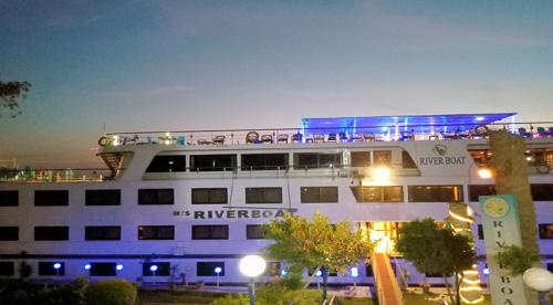 a large cruise ship in a parking lot at night at مركب ريفر River Boat in Cairo