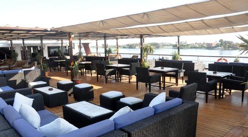 a restaurant with couches and tables and chairs on a deck at مركب ريفر River Boat in Cairo