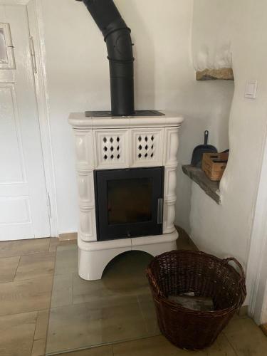 a white fireplace with a stove in a room at Romantická chalupa s krbem in Hořice na Šumavě