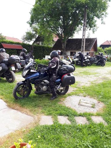 a group of motorcycles parked in the grass at Pensiunea Mateo in Bran