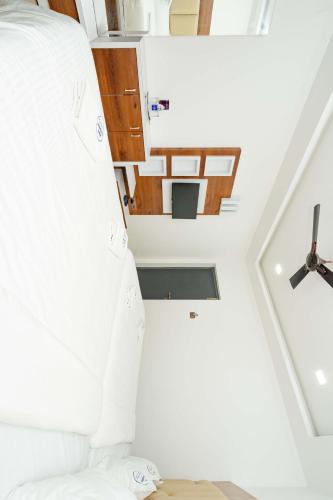 a room with a white bed and a ceiling at HOTEL NATCHATHRA in Rāmeswaram