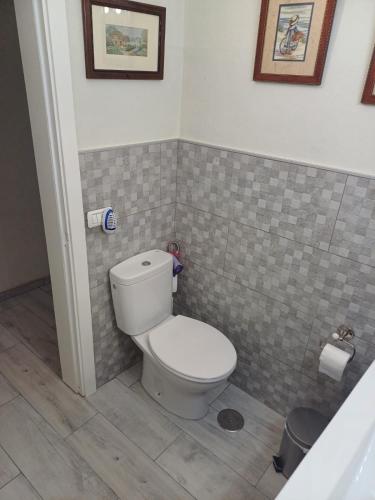 a bathroom with a toilet in a tiled room at Casa Amalia in Agulo