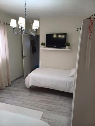 a bedroom with two beds and a flat screen tv at Casa Amalia in Agulo