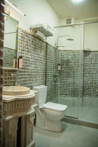 a bathroom with a toilet and a shower and a sink at Kazma Boutique Hotel in Tbilisi City